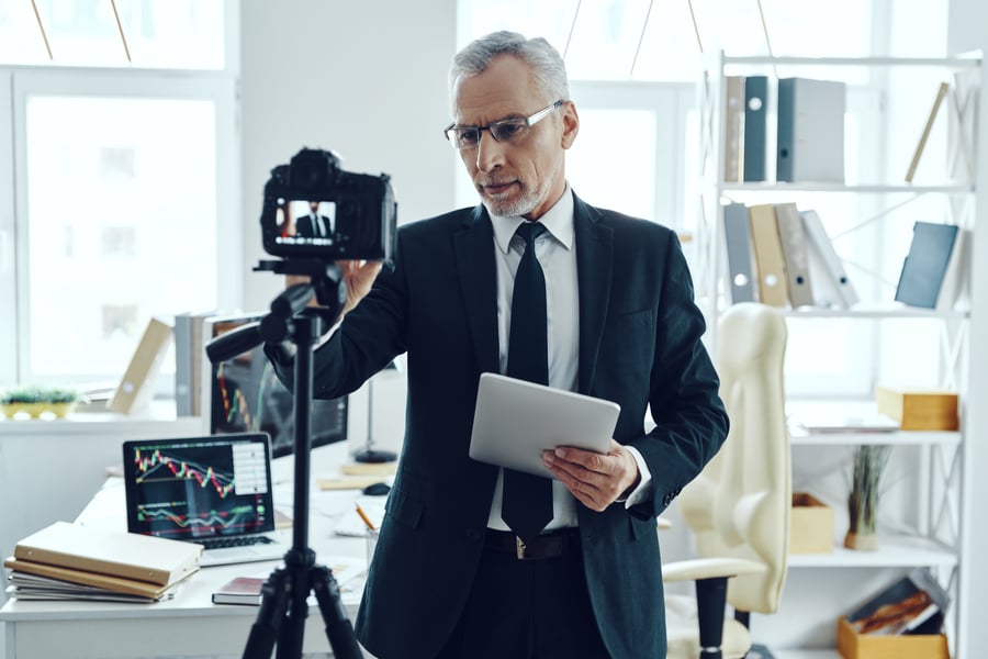 senior-man-in-elegant-business-suit-adjusting-vide-XYJQQSY