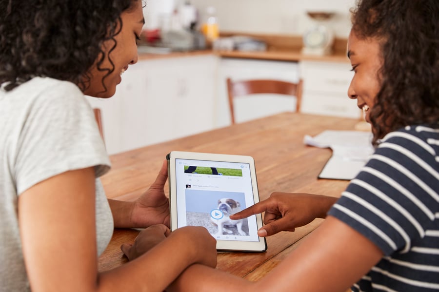 two-teenage-girls-using-social-media-on-digital-ta-PZRN9Y2