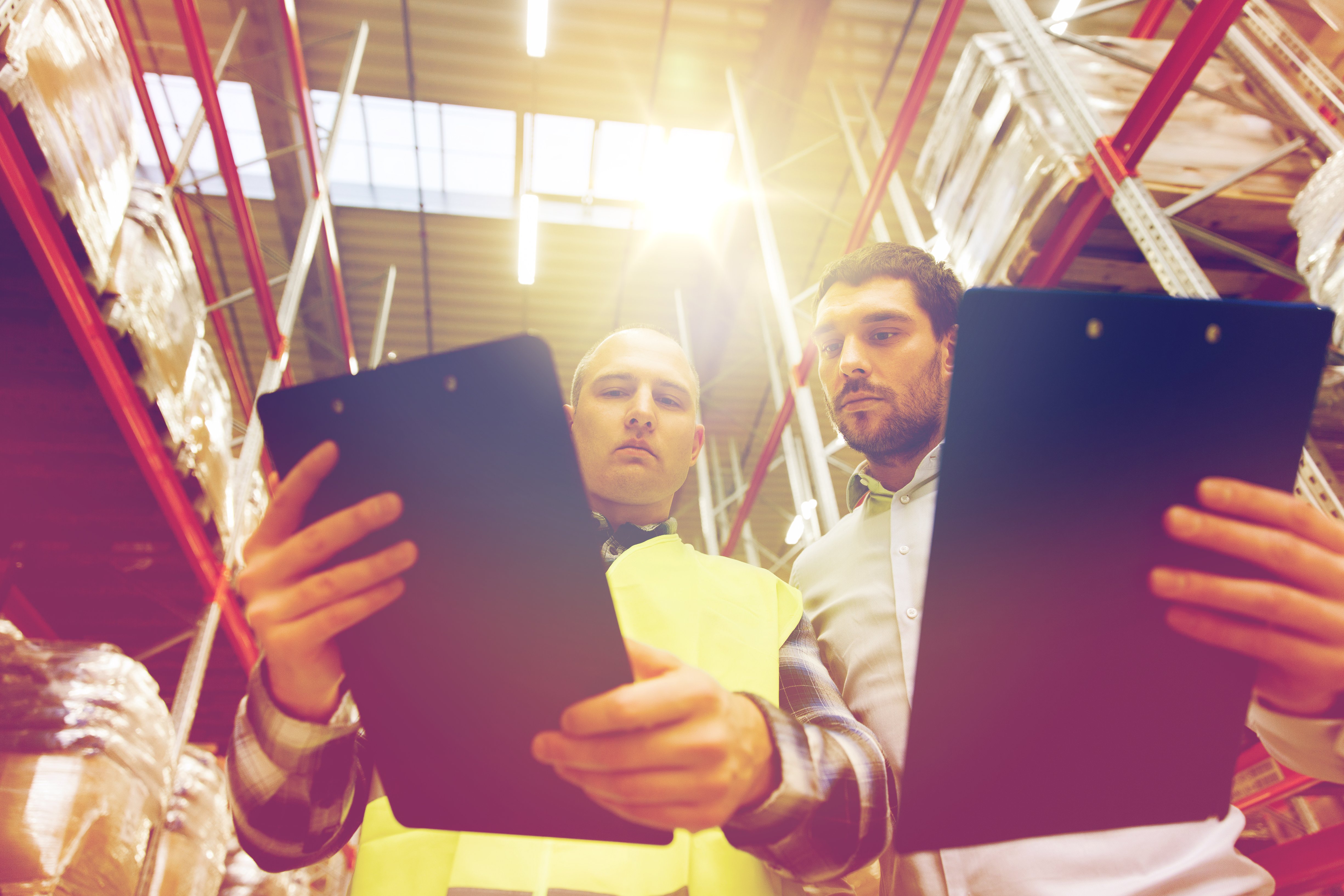 worker-and-businessmen-with-clipboard-at-PSZHY4A