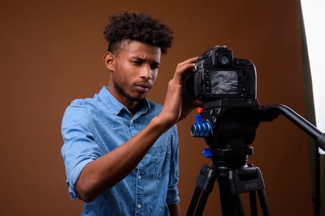 young-handsome-african-man-vlogging-with-dslr-came-9QBL5H8